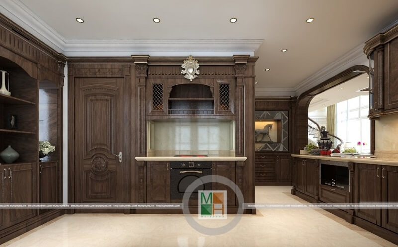 Thiết kế phòng bếp chung cư tân cổ điển có hệ tủ bếp gỗ tự nhiên nâu trầm với kiểu dáng tinh tế, nghệ thuật mang đến vẻ đẹp sang trọng, đẳng cấp cho căn phòng. Thiết kế phòng bếp đẹp và sang trọng